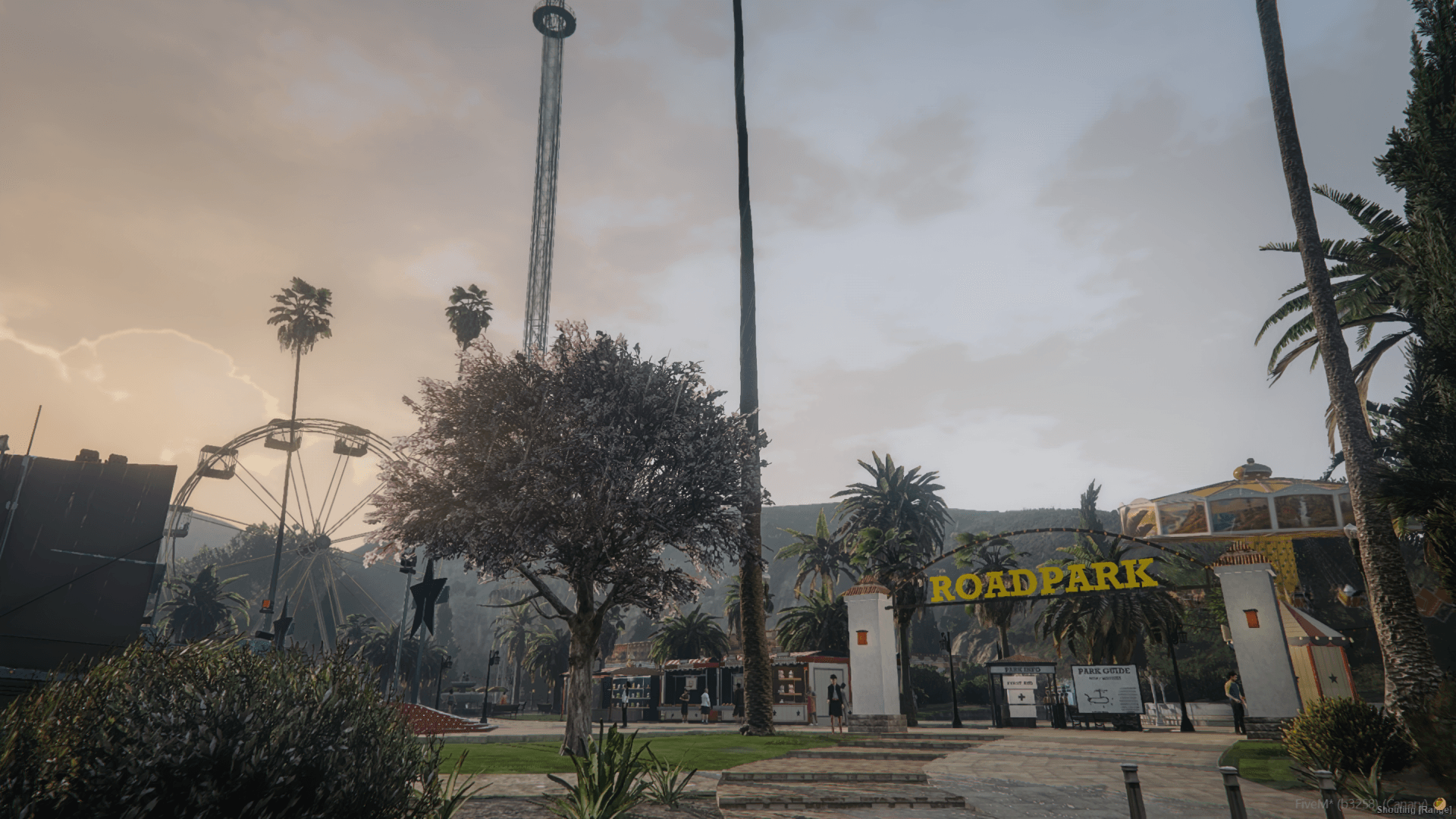 The RoadPark entrance at dusk, with the Ferris wheel and the drop tower behind it